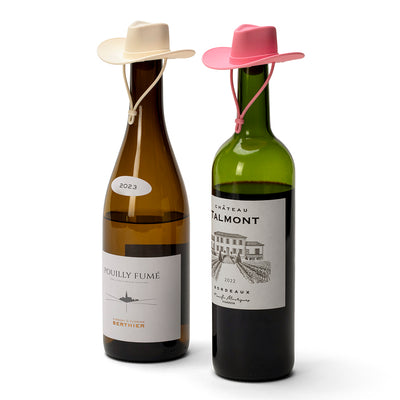 Set of two cowgirl hat silicone wine bottle stoppers for sealing opened wine bottles.